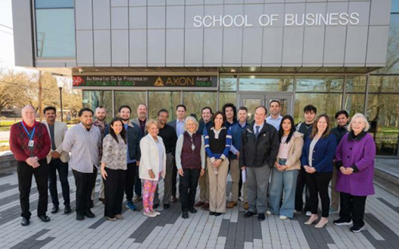 School of Business faculty stand outside in front of southerns school of business