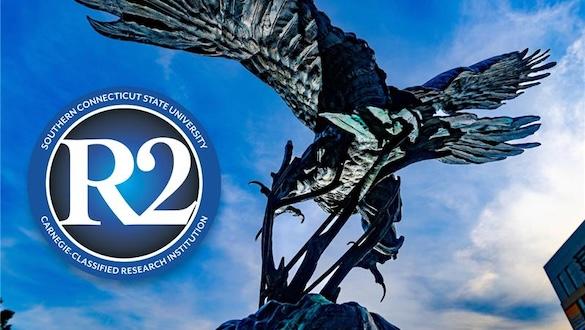 Carnegie R2 Designation logo next to an owl statue