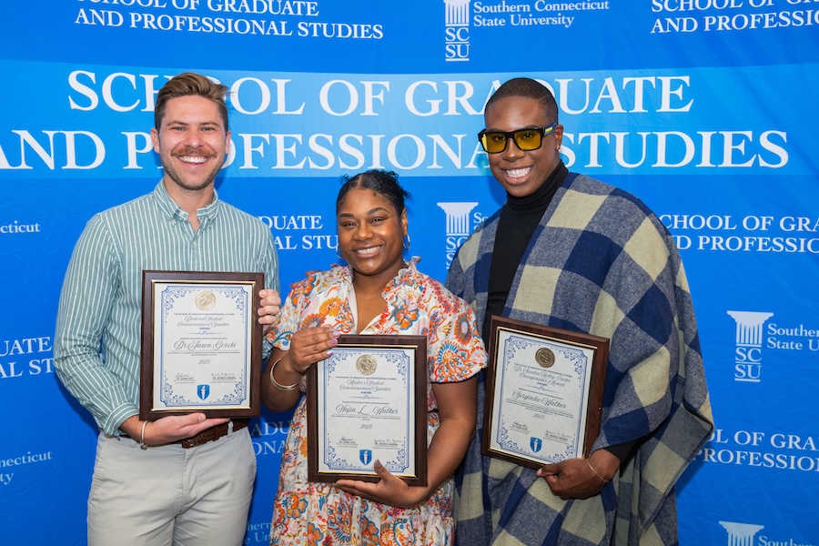 Three graduate students receiving awards